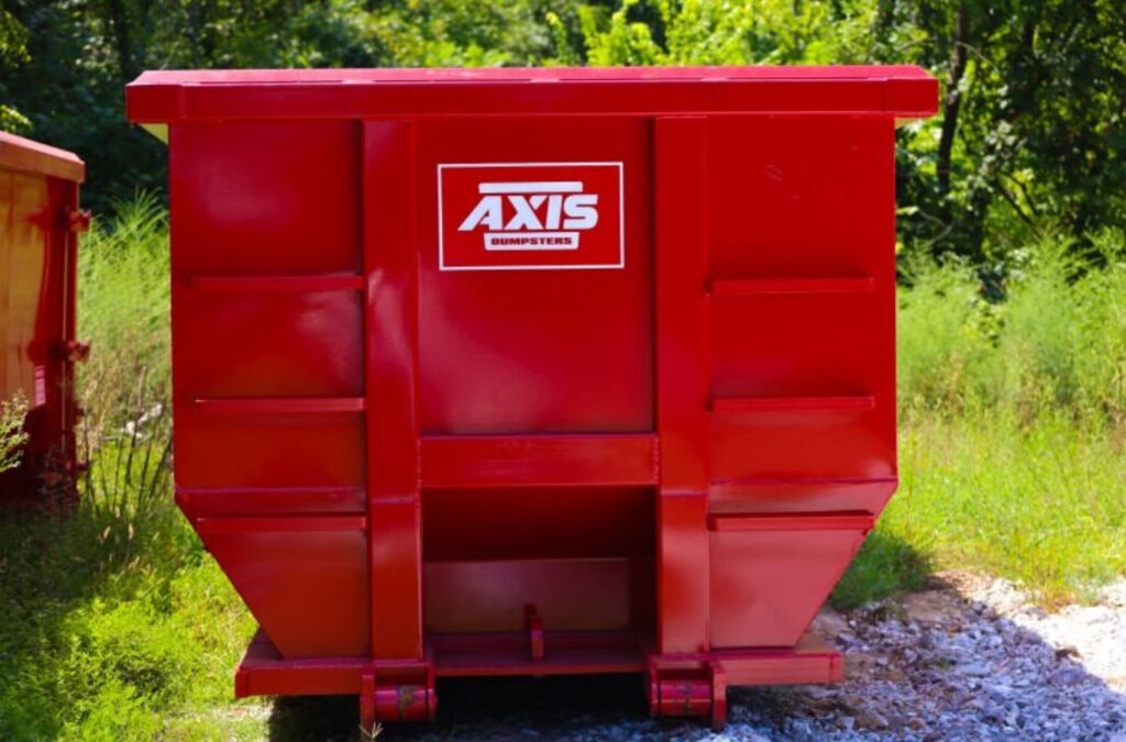 An Axis Dumpsters team member assisting with a construction dumpster rental in Kimberling City, MO, ensuring project efficiency and safety. Construction Dumpster Rental near me.