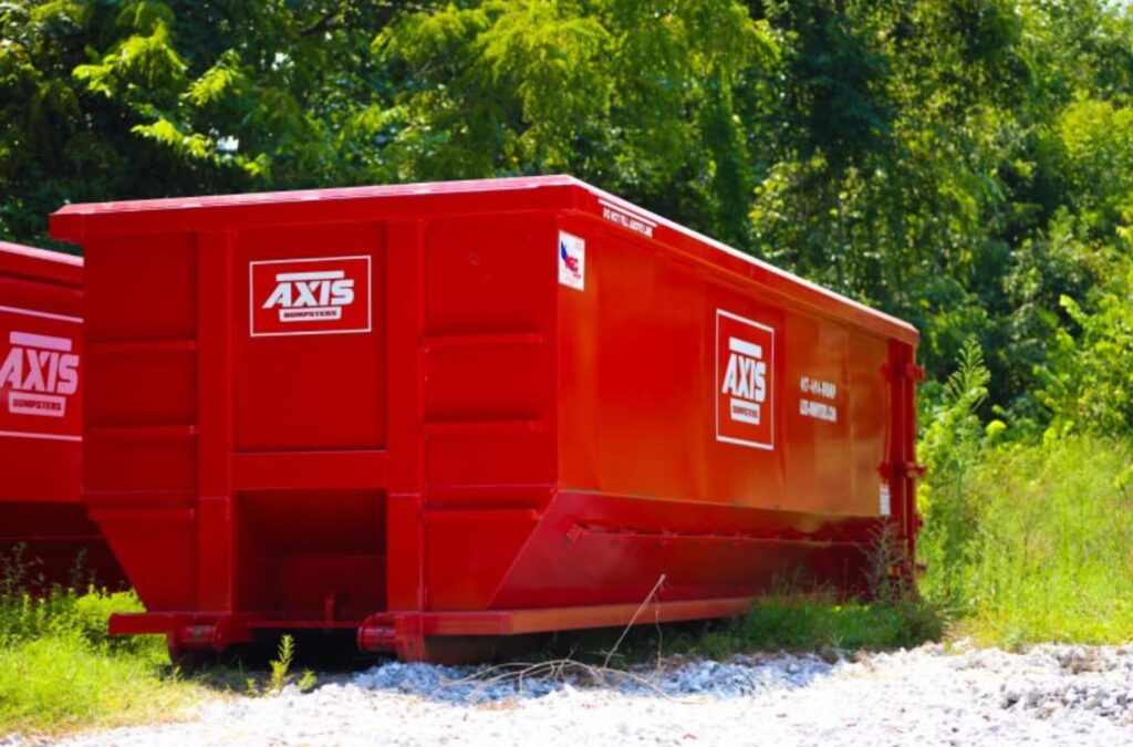 An Axis Dumpsters truck delivering a roll-off dumpster rental in Rogersville, MO, ensuring efficient and professional waste disposal.