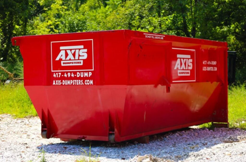 A Axis Dumpsters crew member delivering a dumpster to a Nixa, MO roofing site, highlighting the benefits of reliable and safe waste solutions.